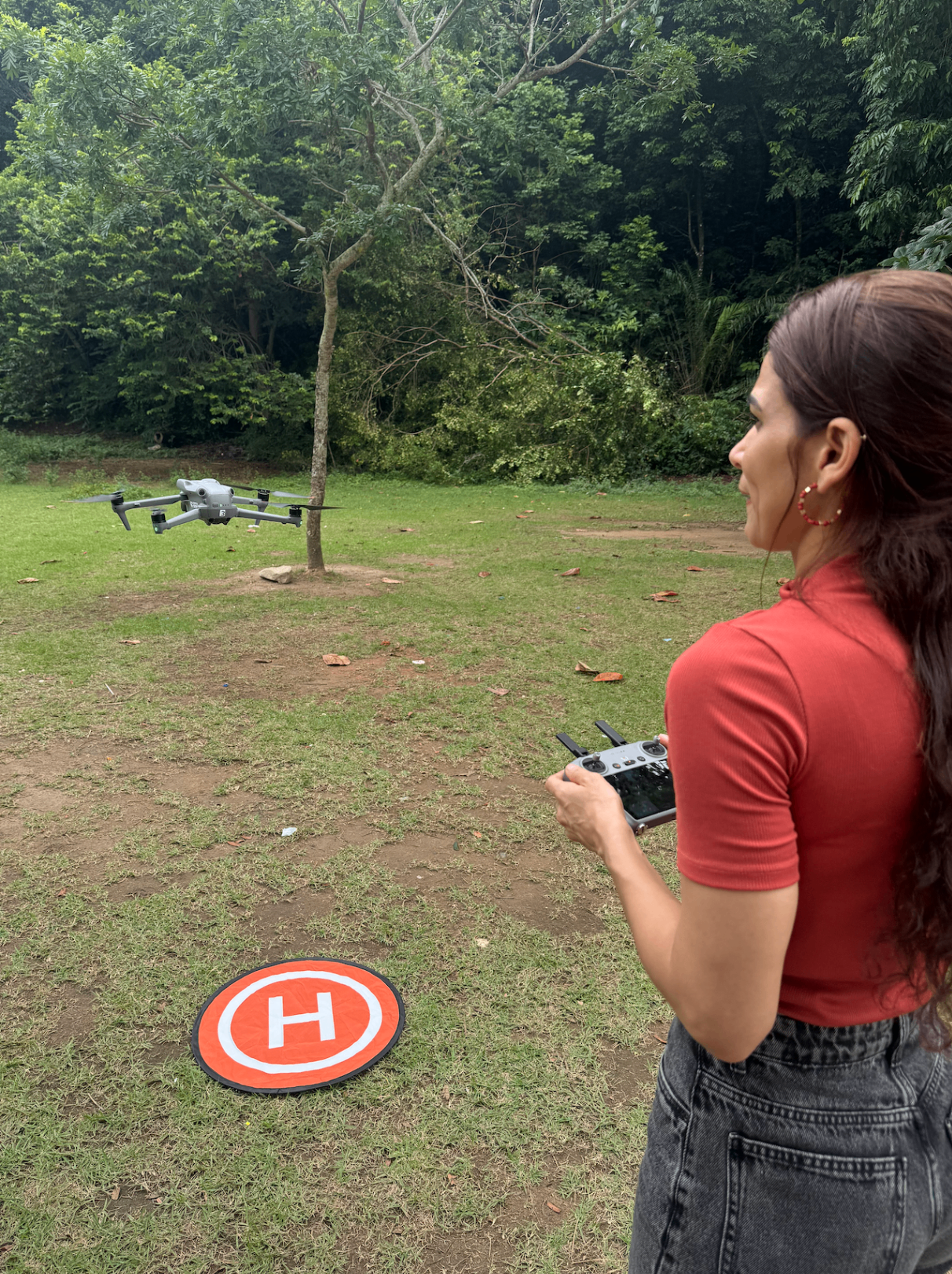Aluna pilotando drone em exercício prático com base de pouso